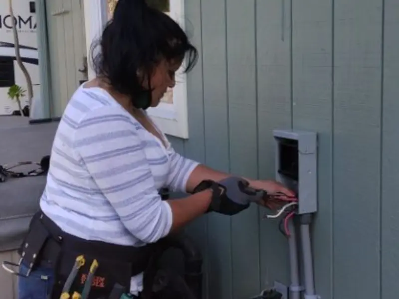 Licensed electrician wiring an exterior subpanel in Indian Head